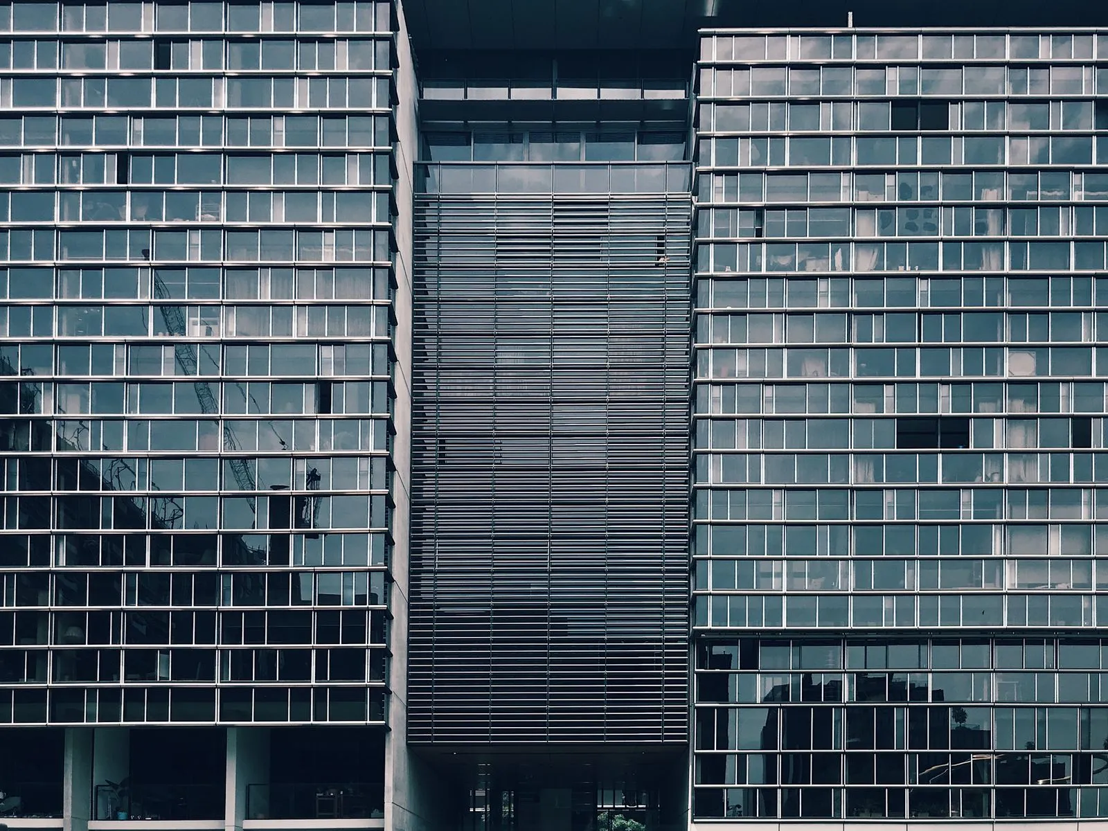 The glass facade of a modern office tower